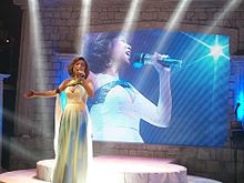 Girado performing "One Moment in Time" on her Timeless: Tribute to a Diva concert.