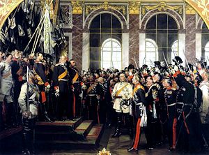 Anton von Werner's depiction of William's proclamation as Emperor in the Hall of Mirrors in Versailles; The Grand Duke of Baden (top step, with hand raised) leads the cheering. Bismarck is in the centre-right wearing white.