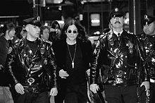 Osbourne, flanked by Philadelphia police officers, leaves Borders in Center City after signing copies of his new autobiography, I Am Ozzy on 27 January 2010.
