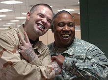 Paul Wall shows off his grills with a smiling fan in Baghdad, 2007.