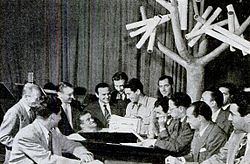 Como meeting with songwriters' representatives in the "Supper Club" studio. He met with the "song pluggers" every Wednesday following the West Coast broadcast of Chesterfield Supper Club.