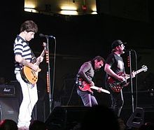 Fall Out Boy in concert. From left to right: Joe Trohman, Pete Wentz, Patrick Stump.
