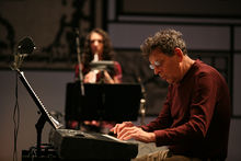 Glass performing Book of Longing in Milan, September 2008