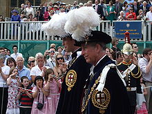 Accompanied by his father, Prince William proceeds to St. George's Chapel to be installed as a Knight of the Garter.