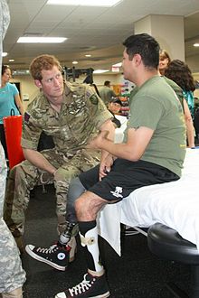 Captain Wales talks to an injured soldier at the Walter Reed National Military Medical Center, 15 May 2013