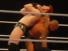 Orton performing the Inverted headlock backbreaker on Sheamus.