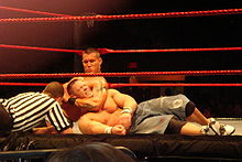Orton applying a chokehold on John Cena