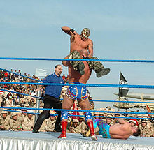 Mysterio preparing for a hurricanrana on Kurt Angle