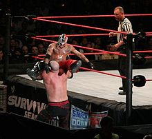 Mysterio attempting a Seated senton on Kane.