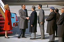 President Nixon shakes hands with Chinese Premier Zhou Enlai upon arriving in Beijing