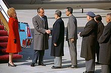 President Nixon shakes hands with Chinese Premier Zhou Enlai upon arriving in Beijing
