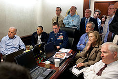 Gates sitting with Obama, Biden, and the U.S. national security team gathered in the Situation Room to monitor the progress of Operation Neptune Spear.