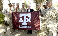 US Secretary of Defense Robert Gates gives a gig 'em with a group of Aggie Marines at Camp Fallujah, Iraq