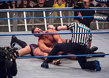 Roode performing the crossface on Austin Aries.