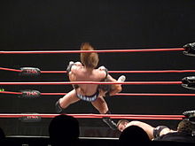 Roode performing a spinebuster on Mark Haskins.
