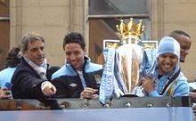 Mancini (left), Samir Nasri and Sergio Agüero with the Premier League trophy during Manchester City's victory parade, May 2012.