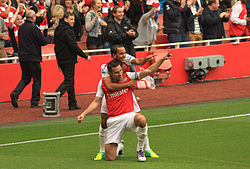 Van Persie celebrates scoring with Theo Walcott in 2011.