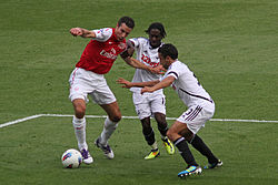Van Persie holding off Nathan Dyer and Neil Taylor of Swansea City