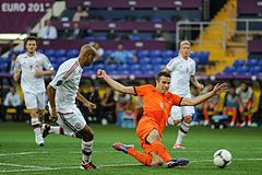 Van Persie attempting a shot against Denmark at UEFA Euro 2012.