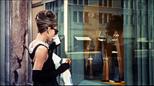 Hepburn in the opening scene of Breakfast at Tiffany's (1961), wearing the iconic little black dress by Givenchy