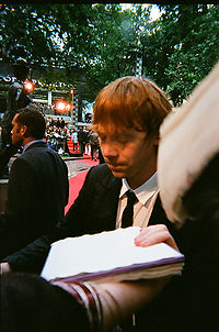 Grint signing autographs at the 2009 premiere of Harry Potter and the Half-Blood Prince