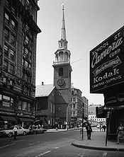 The Old South Meeting House (1968 photo shown) was Adams's church. During the crisis with Great Britain, mass meetings that were too large for Faneuil Hall were held here.[24]