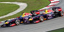 Vettel's controversial pass at the 2013 Malaysian Grand Prix. Vettel (left) overtook team-mate Mark Webber (right) despite being ordered by his team not to do so.
