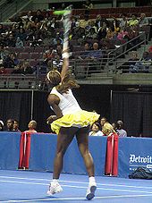 Delivering a serve at an exhibition in November 2004.