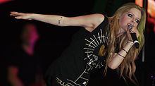 Lavigne's XXV and star tattoos on her right forearm, and 30, lightning bolt, and star tattoos on her left wrist.