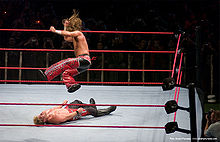 Michaels performing a diving elbow drop on Chris Jericho