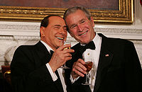 Berlusconi and George W. Bush laughing and drinking in 2008.