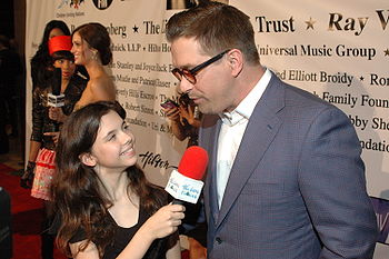 Baldwin talks on the red carpet of a Children Uniting Nations party, 2009.