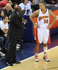 Curry taking instructions from Warriors then-assistant coach Keith Smart.