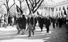 Ted Kennedy, accompanied by Robert F. Kennedy and Jacqueline Kennedy, walking from the White House for the funeral procession accompanying President Kennedy's casket to Cathedral of St. Matthew the Apostle