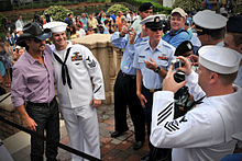 Tim McGraw poses for a sailor at Ponte Vedra Beach, Florida on May 5, 2010, before performing at the Tournament Players Club at Sawgrass military appreciation day.