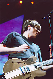 DeLonge performing in 2004 with his standard Gibson Tom DeLonge Signature ES-333 guitar.