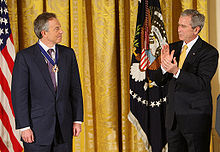 Blair is presented with the Presidential Medal of Freedom by then US President George W. Bush.