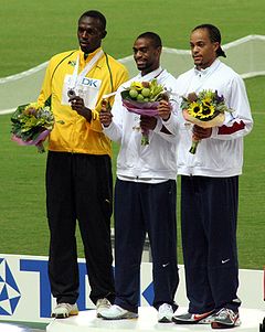 Gay (center) receiving his World Championship gold medal alongside Usain Bolt (left) and Wallace Spearmon (right).