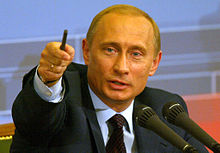 Putin during one of his annual Q&A conferences, indicating with his pen.