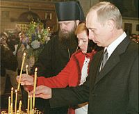 Putin and his wife, Lyudmila, attending a commemoration service for the victims of the September 11 attacks in St. Nicholas Cathedral, New York, 16 November 2001.
