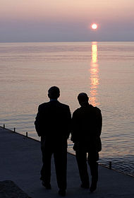 George W. Bush and Vladimir Putin take a sunset walk on a pier along the Black Sea, 5 April 2008