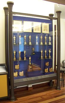 This display case in the lobby of the Walt Disney Family Museum in San Francisco shows many of the Academy Awards he won, including the distinctive special award at the bottom for Snow White and the Seven Dwarfs.
