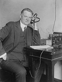 Secretary of Commerce Herbert Hoover listening to a radio