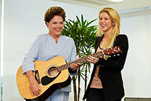 Brazil's president Dilma Rousseff receiving a guitar for Shakira's charity auction (2011).