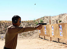 Woods shoots a handgun during training at a shooting range outside San Diego.