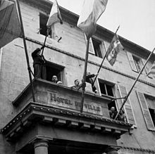 General de Gaulle delivering a speech in liberated Cherbourg from the Hôtel de ville (town hall)