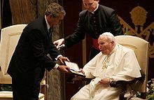 US President George W. Bush presents the Medal of Freedom to Pope John Paul II, in June 2004