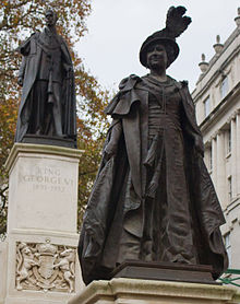 Bronze Statue of Queen Elizabeth on The Mall, London, overlooked by the statue of her husband King George VI