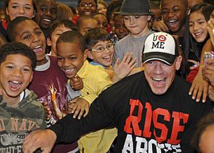 Cena posing with children