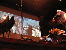 John Williams conducting the score to Raiders of the Lost Ark in the Avery Fisher Hall.